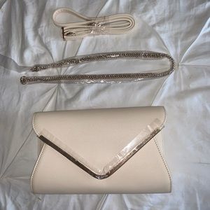 Cream colored purse with 2 interchangeable straps